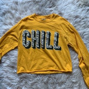 A yellow cropped shirt